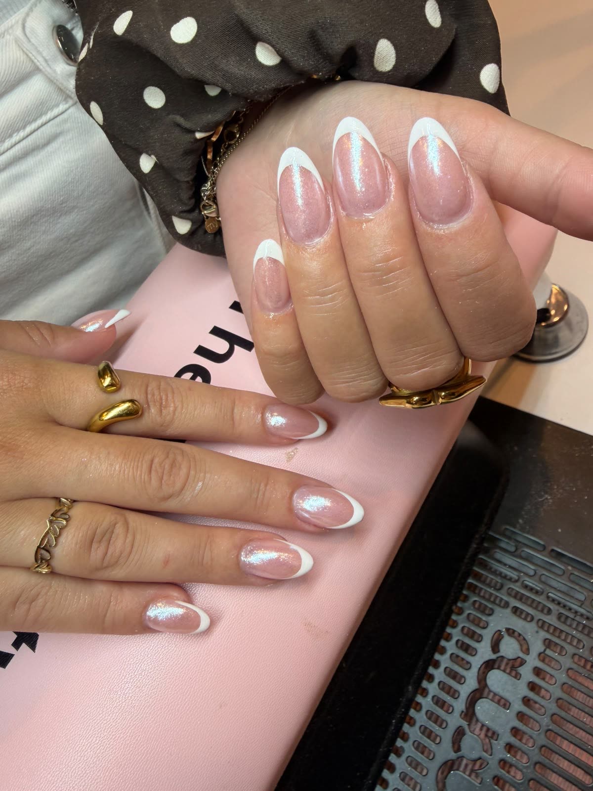 French manicure met iriserende shimmer en chunky gouden ringen