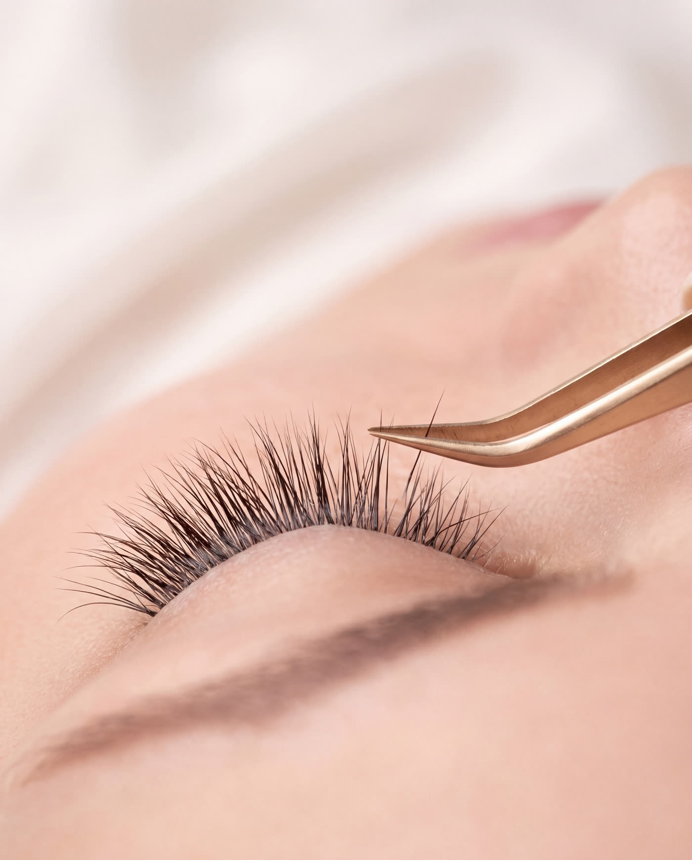 Closed eye with fine, softly fanned eyelash extensions
